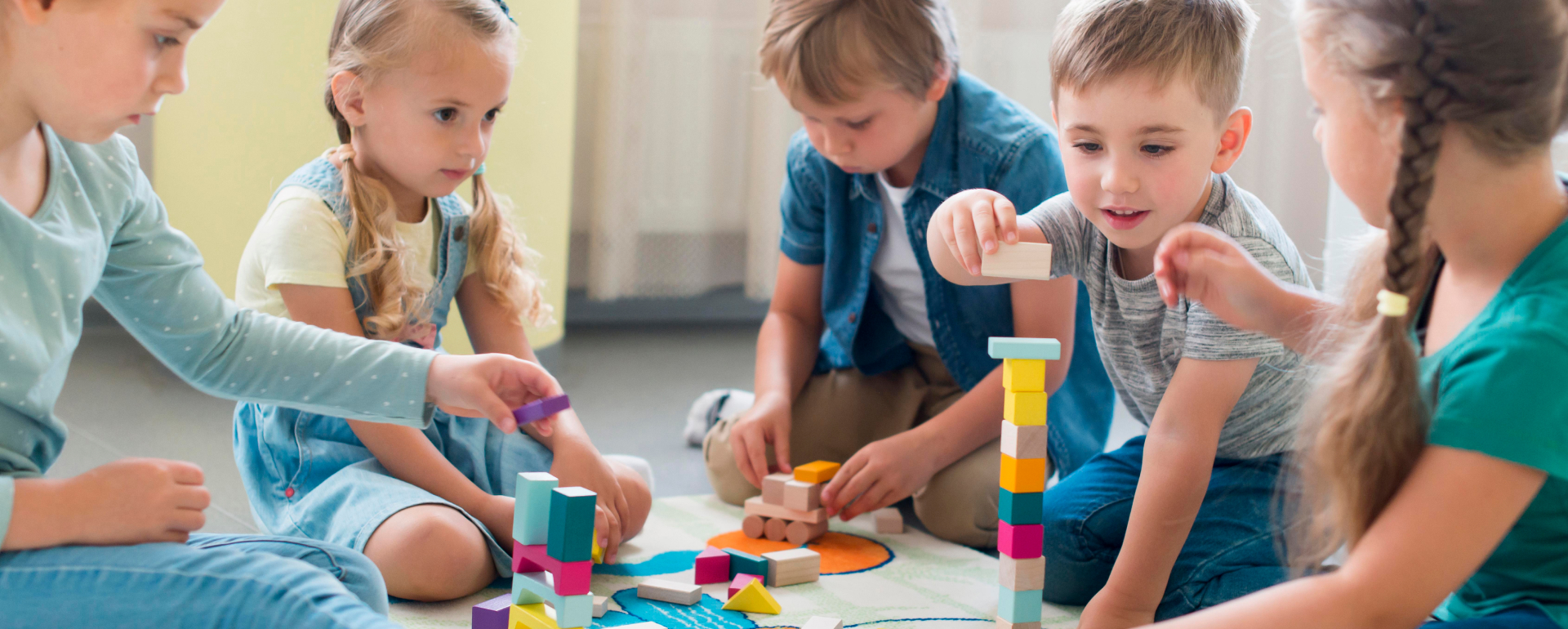 Children playing with colorful wooden blocks
