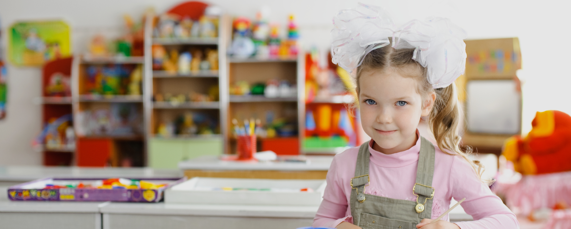 Smiling girl in colorful preschool classroom